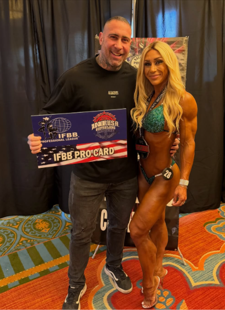Diego alongside a competition athlete holding an IFBB Pro Card at the USA Championships